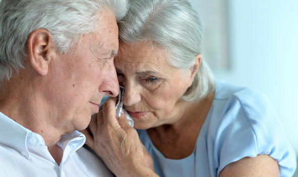 portrait-of-sad-senior-couple-posing-at-home.jpeg