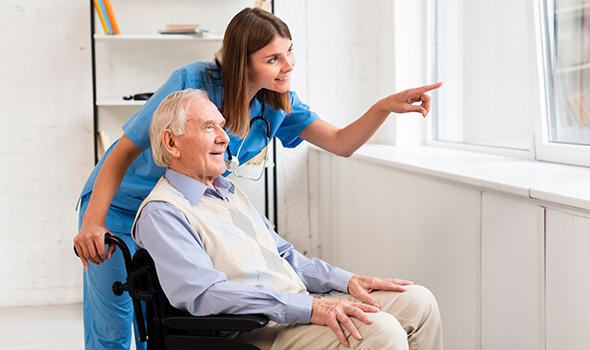 Freepik_nurse-pointing-to-the-window-while-talking-to-old-man_freepik.jpg