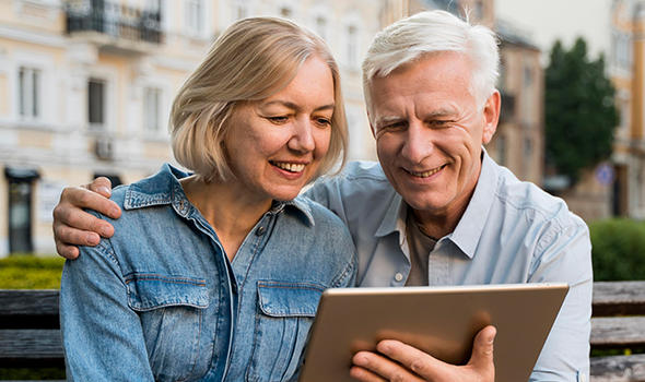 Freepik_smiley-older-couple-looking-at-something-on-tablet_freepik.jpg