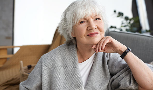 Freepik_age-retirement-and-relaxation-concept-happy-cheerful-mature-retired-woman-looking-with-beaming-smile-enjoying-nice-winter-day-sitting-on-couch-wrapped-in-wide-scarf-dreaming_shurkin_son.jpg