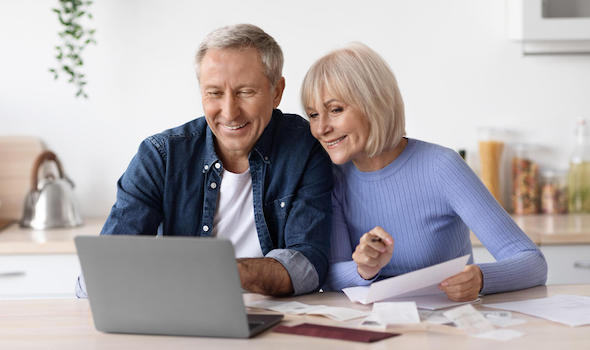 happy-pensioners-sittting-in-front-of-computer-reading-emails.jpeg