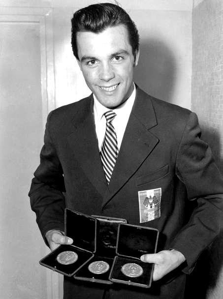 Toni_Sailer_with_3_gold_olympic_medals_at_Cortina_1956.jpg