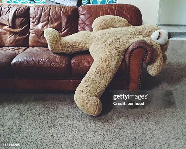 stuffed-teddy-bear-laying-on-couch.jpg